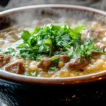 Old grandma recipes beef and barley soup steaming in a bowl